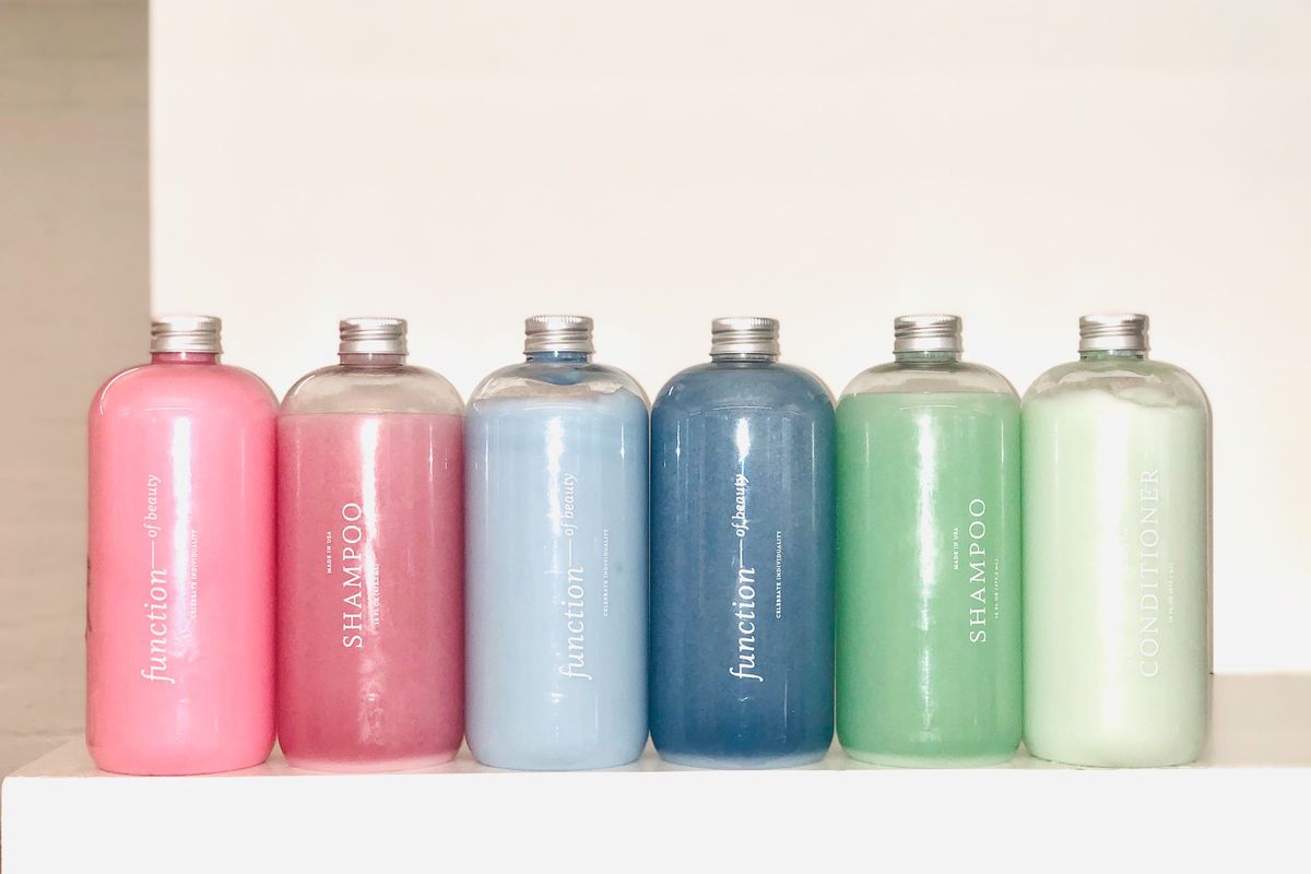 a row of 6 brightly colored shampoo bottles