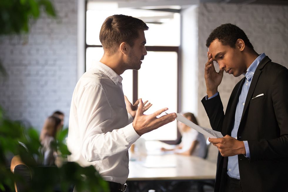 Young man getting off on the wrong foot with his co-worker in the office.