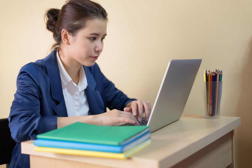 Young professional uses her writing skills at her job.