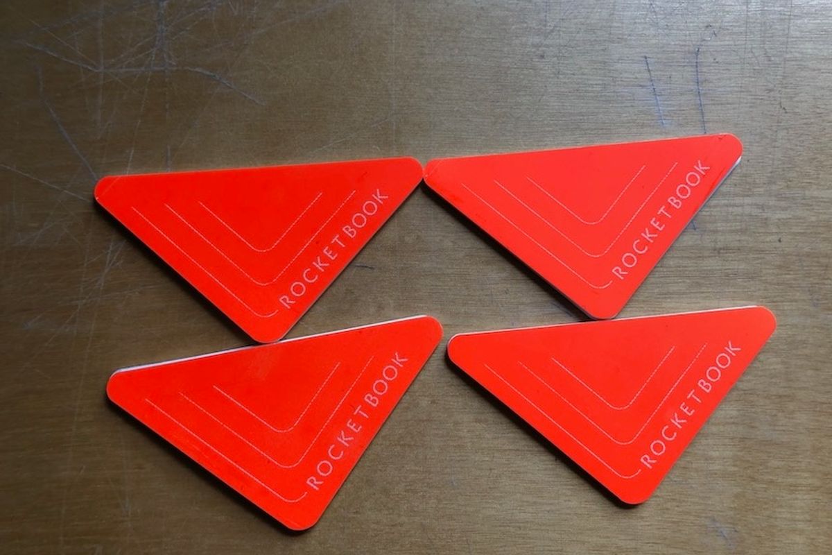 Four orange Rocketbook Beacons stickers