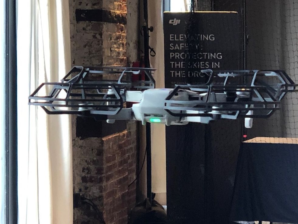 A DJI Mavic Mini flying in mid-air