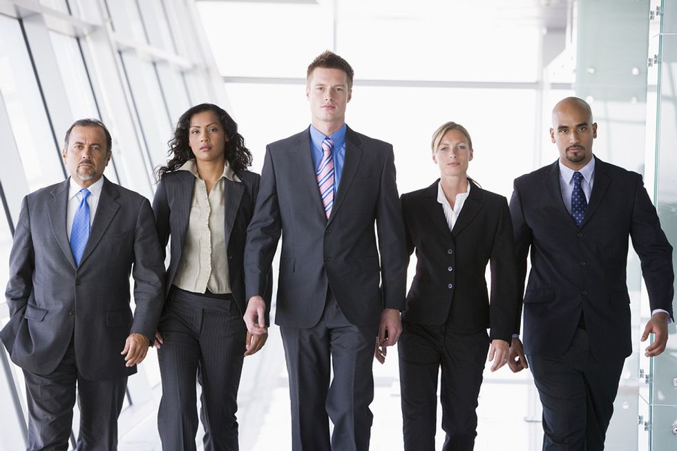A group of co-workers walk together at work.
