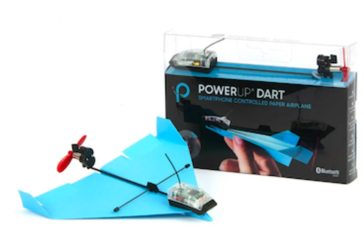 A PowerUp Dart in blue next to the packaging on a white table