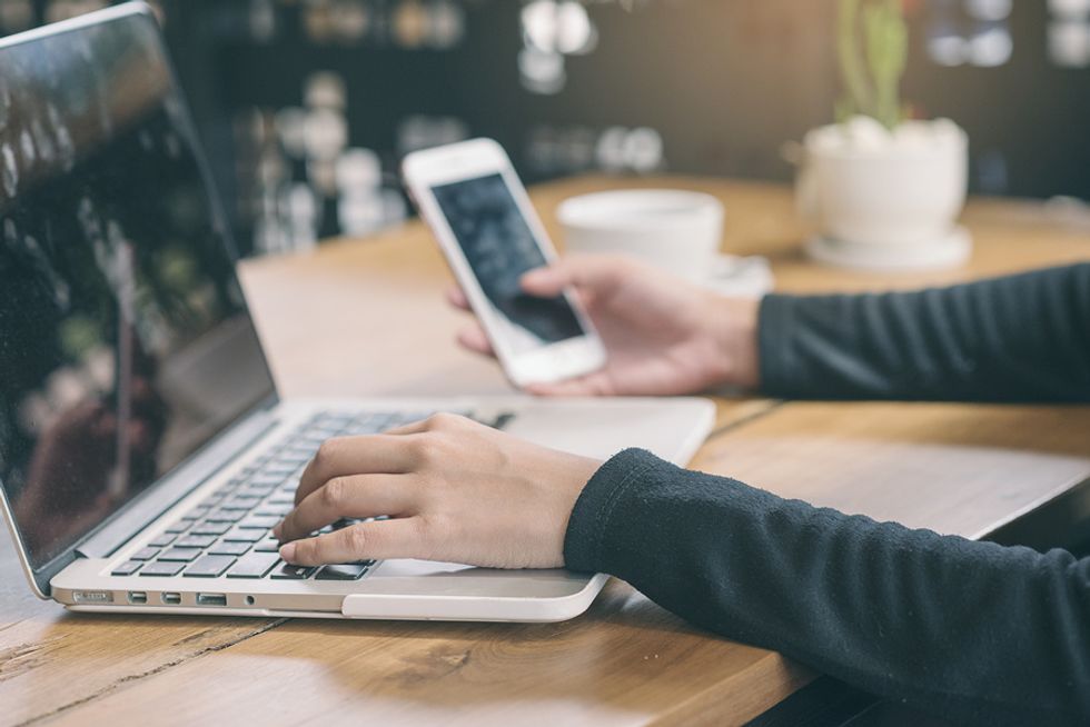 Businesswoman researches a company on social media.