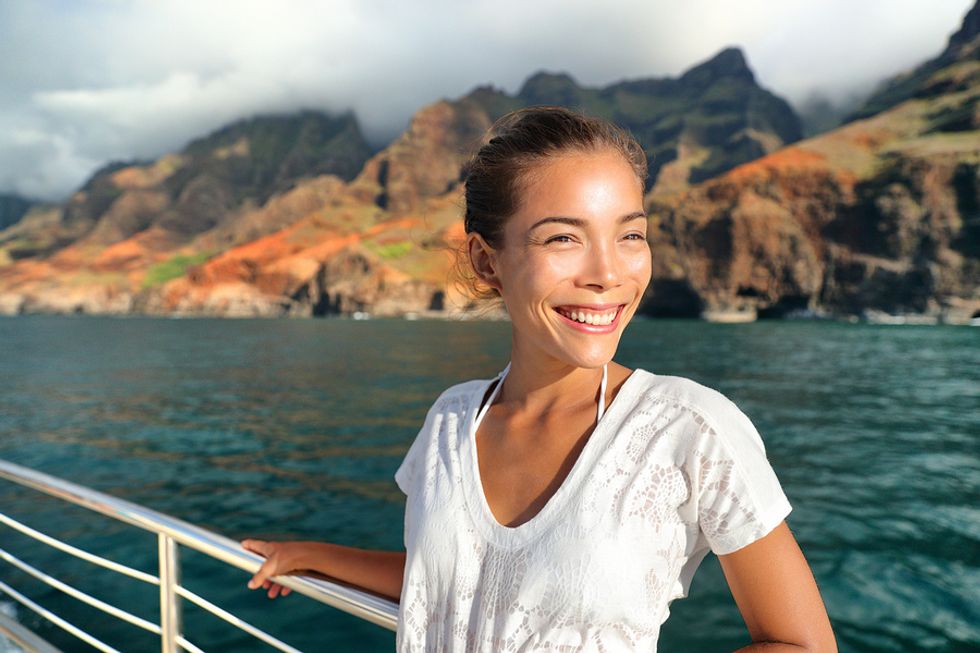 Woman smiling on a cruise ship as she prepares for her job as a cruise ship worker.