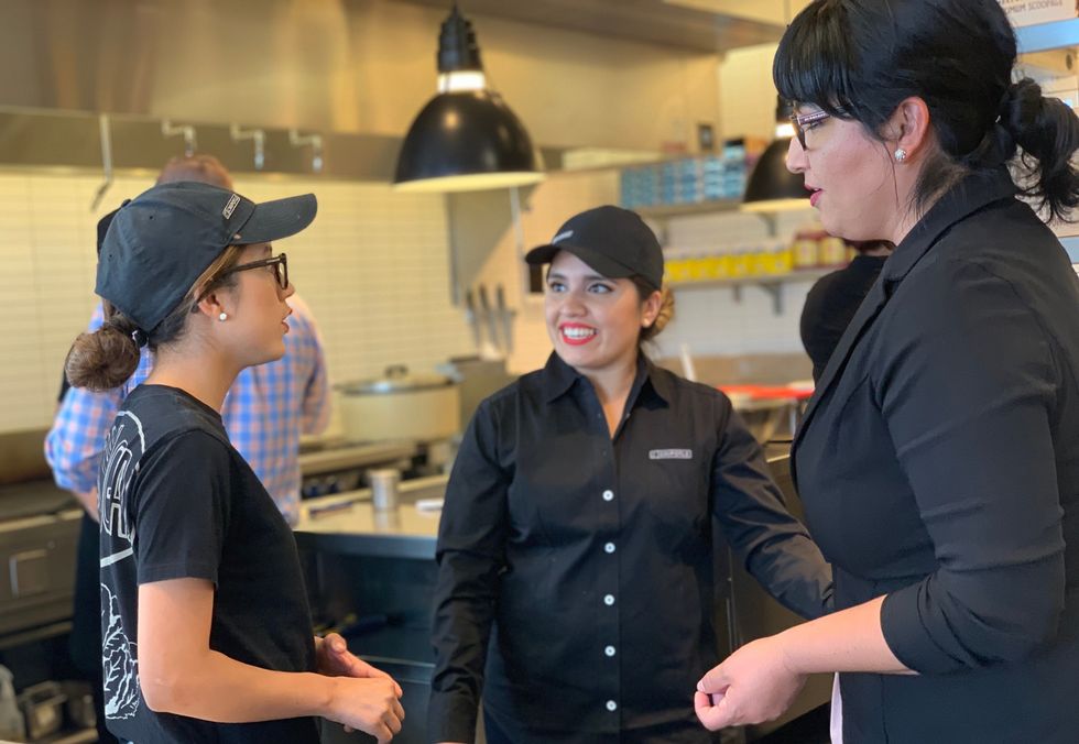 Chipotle employees chat during their shift.