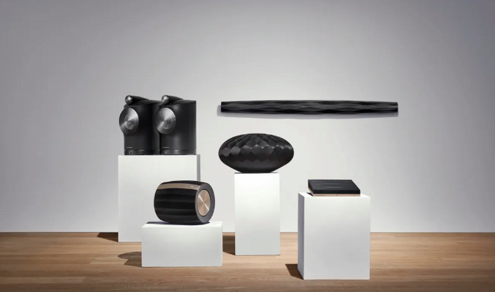 Bowers & Wilkins line of speakers and add-ons in black on white pedestals