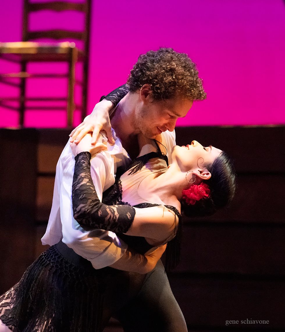 Cory Stearns and Sarah Lane embrace onstage. Sarah wears a short, black, lacy dress and a rose in her hair.