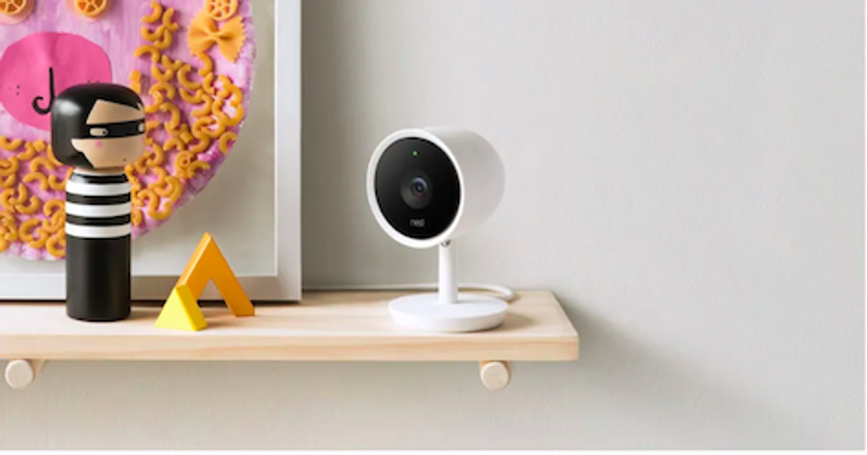 The Nest Cam on a shelf against a white wall