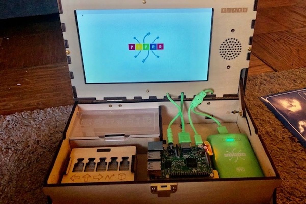 A Piper Computer Kit 2 put together with the display lit, and reading 'Piper'