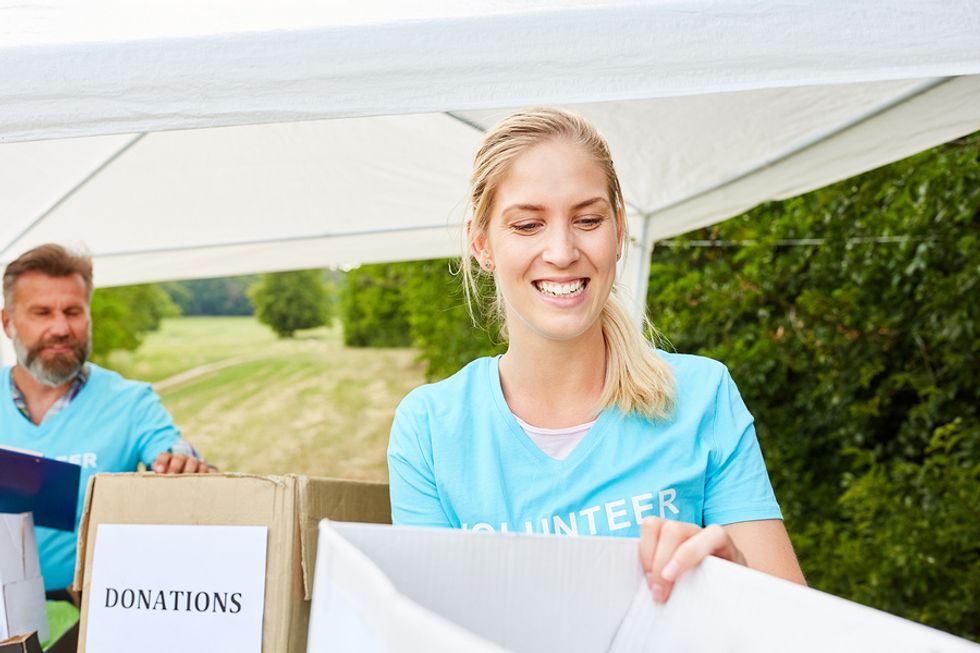 Young unemployed woman volunteering at a donation drive to fill time while she looks for a job.