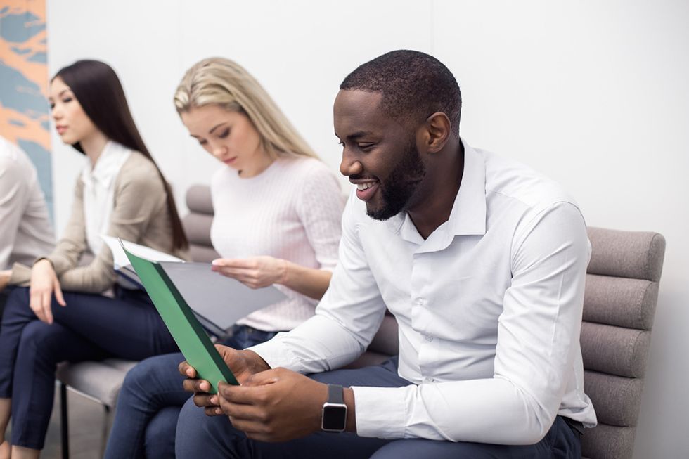 Teacher looking at his resume and remembering to sell himself in the job interview