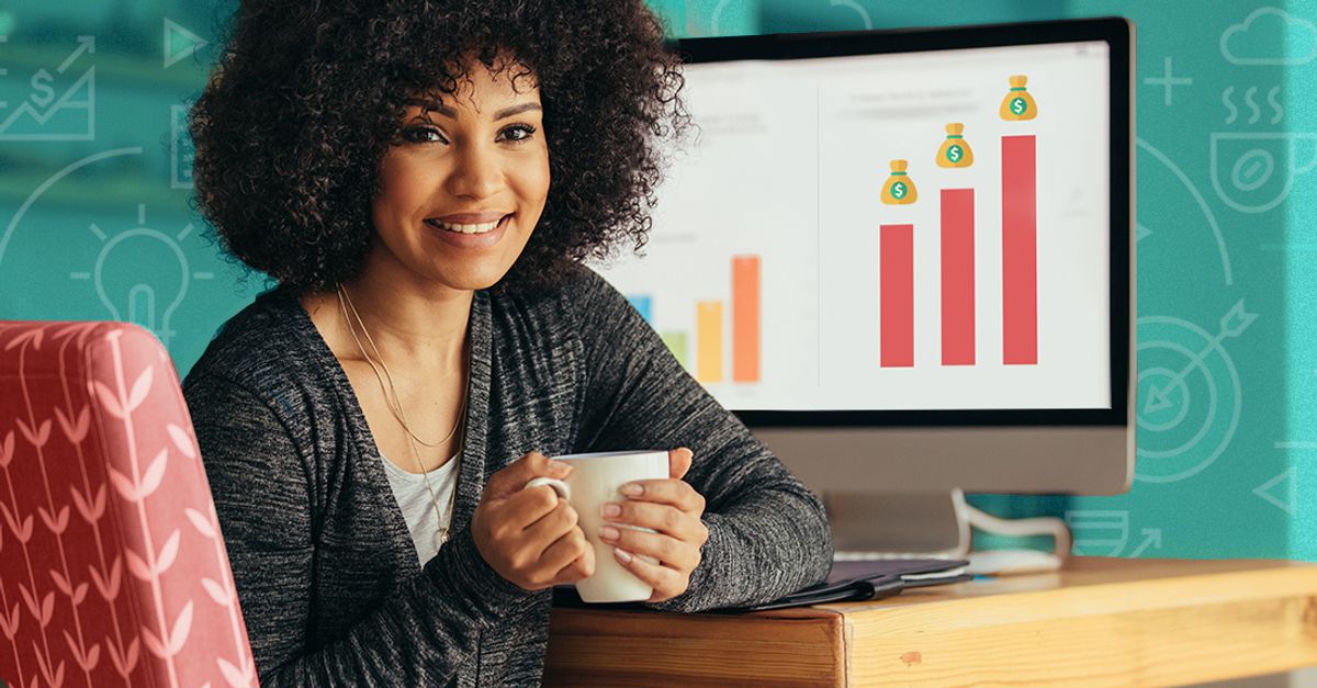 Woman sitting at her computer with coffee.