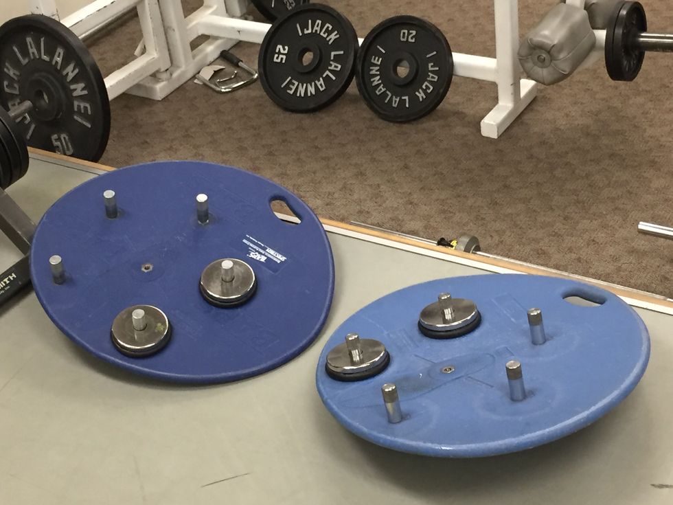Blue circular boards with metal pieces sticking out of them.