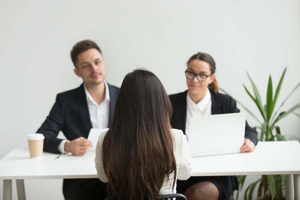 Hiring managers judging potential job candidate on her appearance in an interview