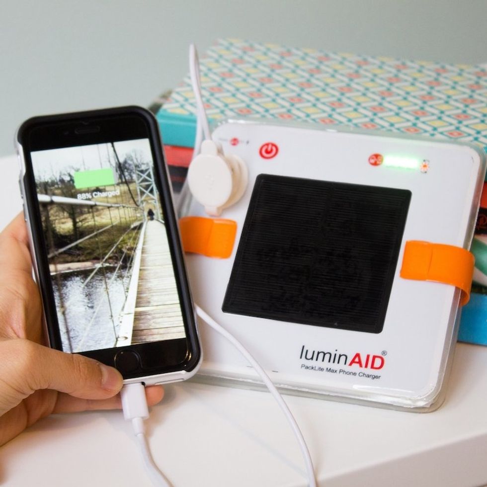 A LumidAid charger connected to a smartphone via a cable