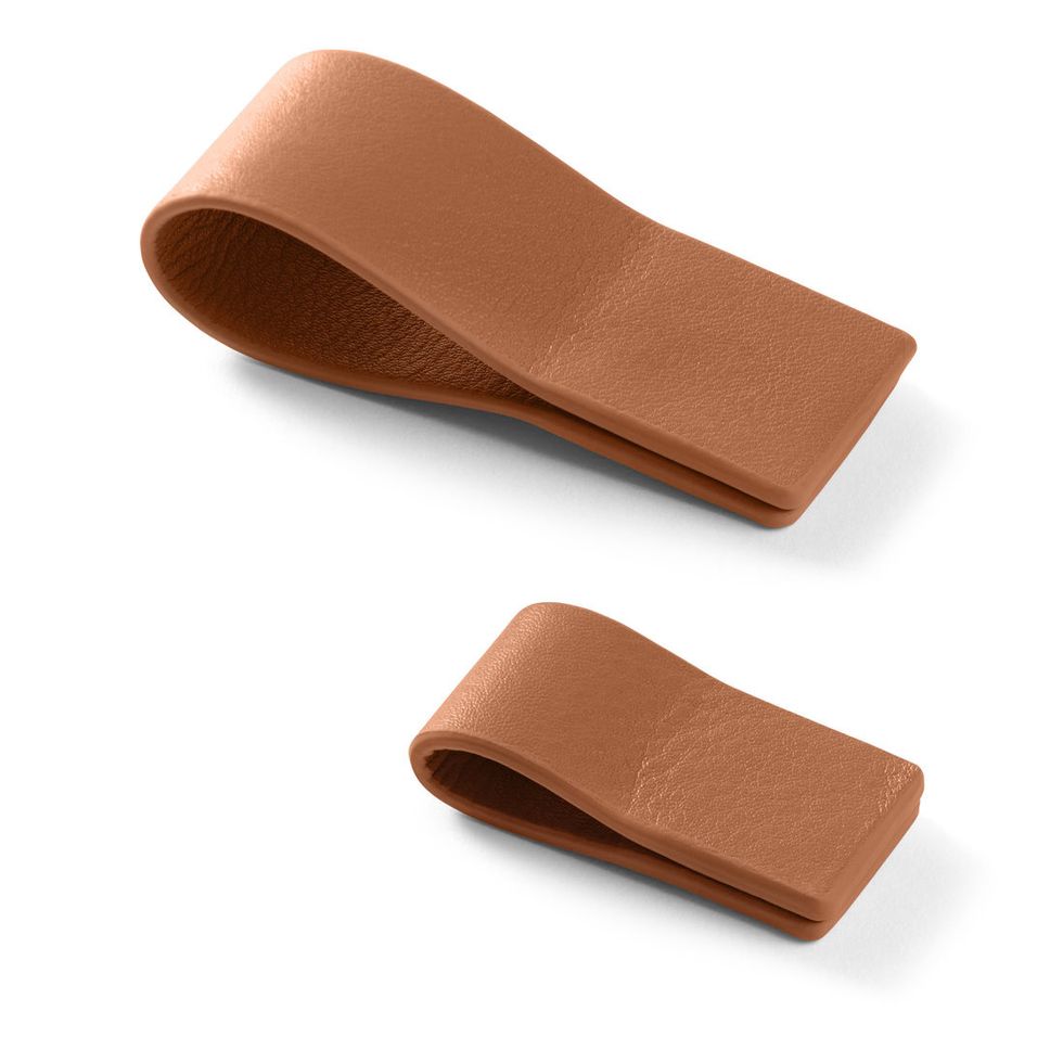 Two brown leather clips on a white background