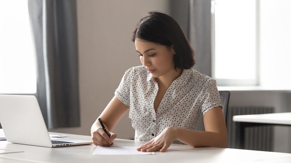 Job seeker writing an outstanding personal branding statement