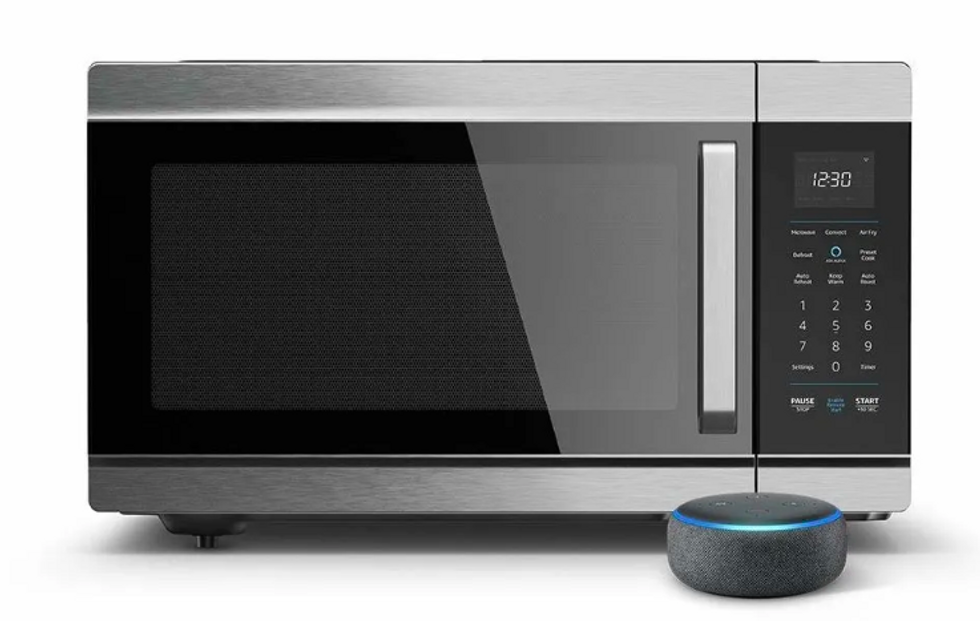 The Amazon Smart Oven next to an Echo Mini,  against a white background