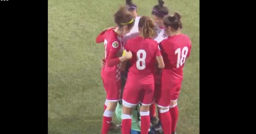 Opposing team members beautifully surrounded a soccer player whose hijab came off