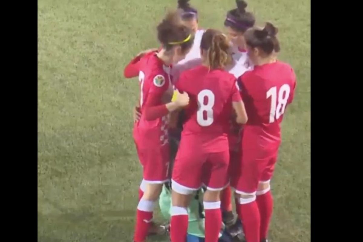 Opposing team members beautifully surrounded a soccer player whose hijab came off