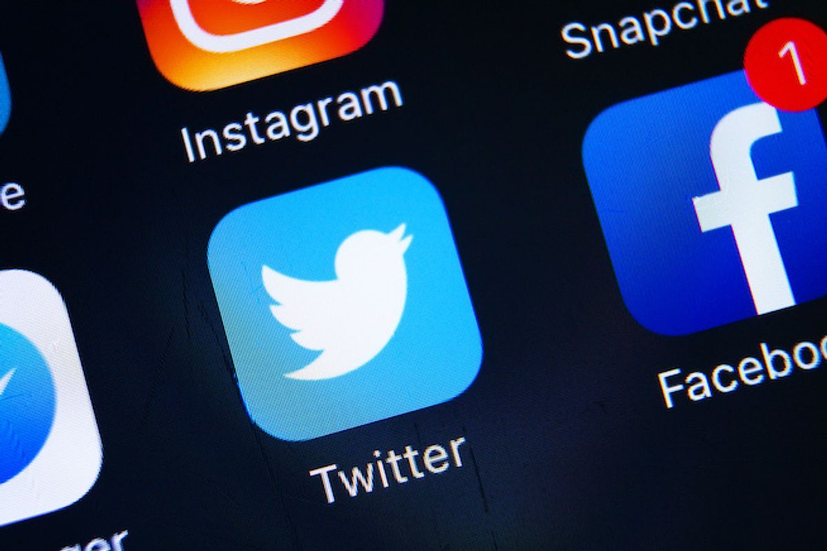 Twitter icon on a screenshot surrounded by other social media logos