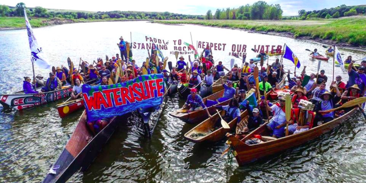 Canoe People [Nisqually, Puyallup, Quinault, Chehalis/Colville, Kalispel, Warm Springs, Coeur d’Alene, Kootenai, as well as from Idaho, Minnesota, Missouri and Alaska] and Horse People [Oceti Sakowin] come together during the Paddle to Standing Rock on September 9, 2016, 