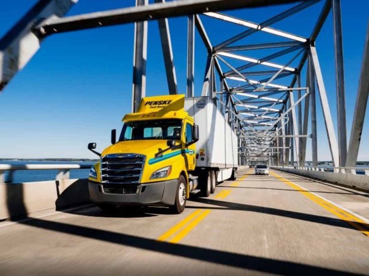 Penske tractor driving over bridge