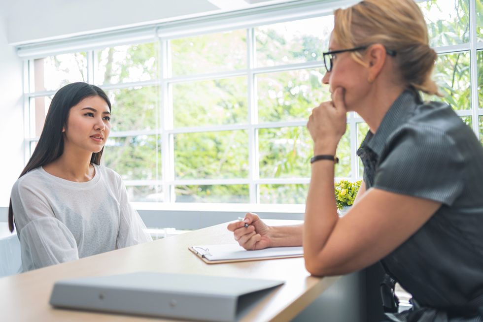 Young woman listens attentively during a job interview.