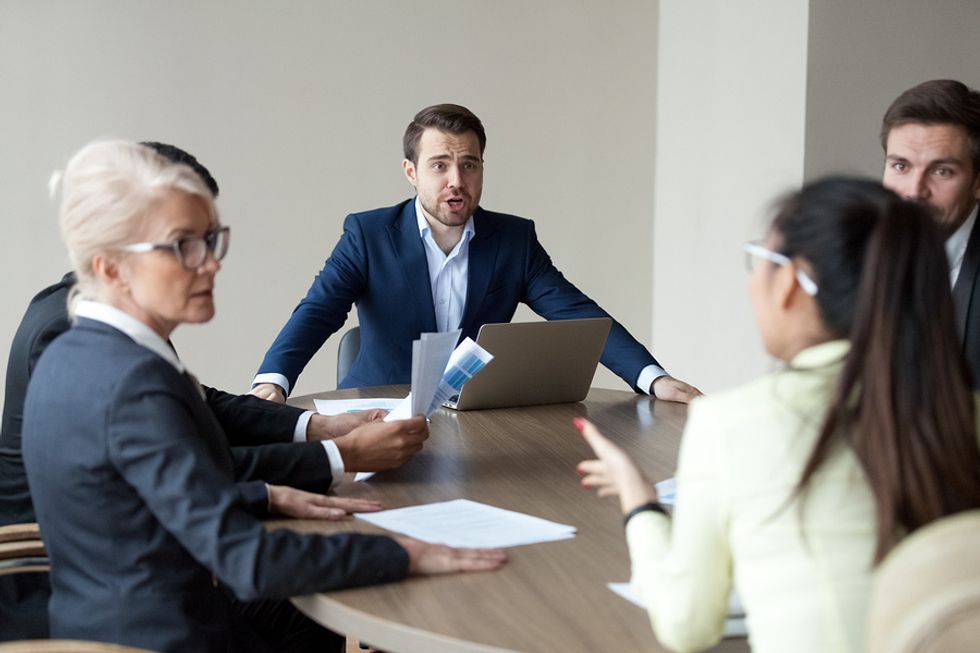 Two executives argue during a meeting