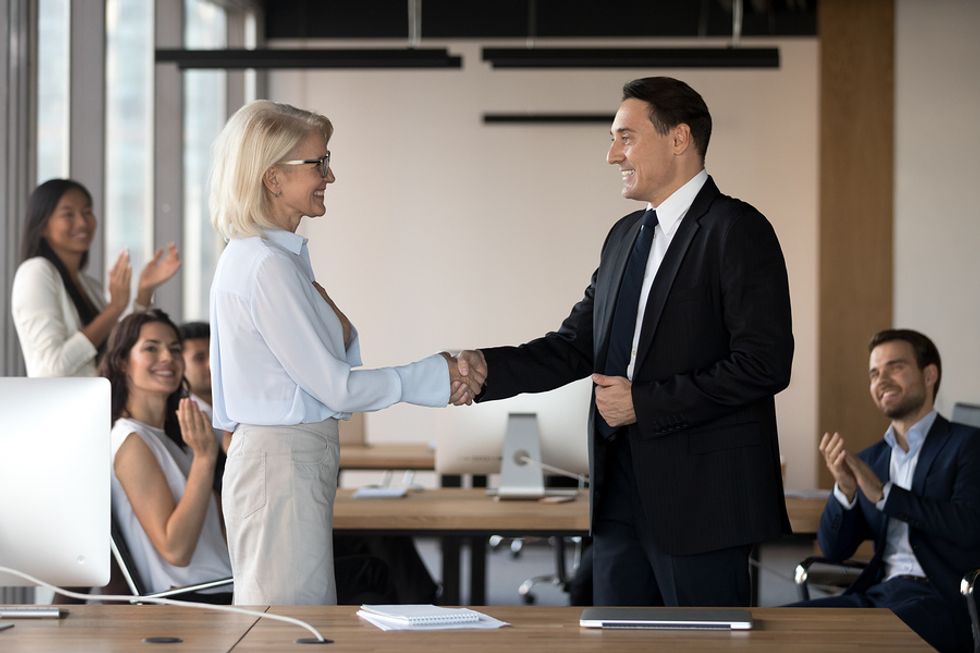 Employees congratulate their new CEO on his executive job