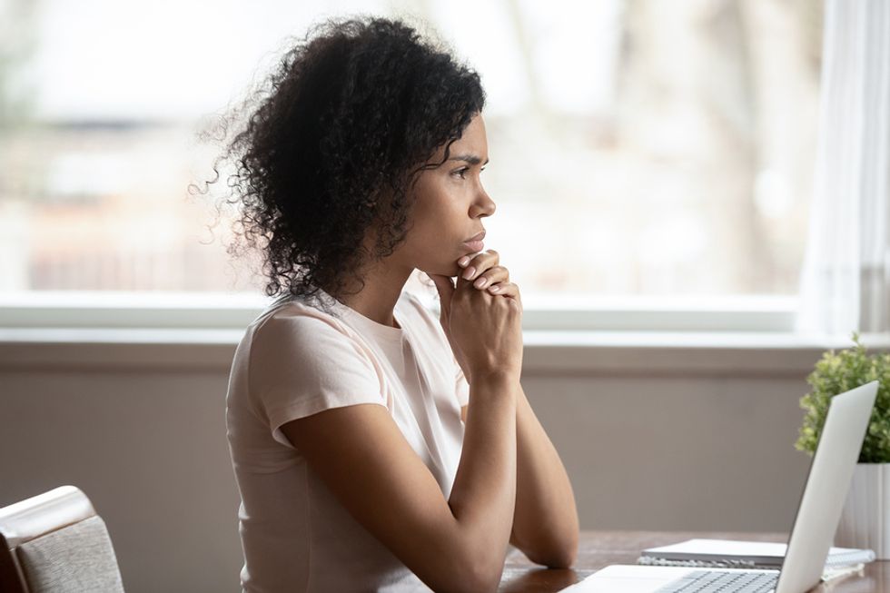 Professional woman thinking about how she can be better at self-promotion