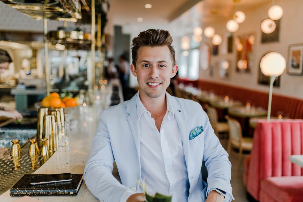 \u200bmillennial man sitting at a counter thinking about his career