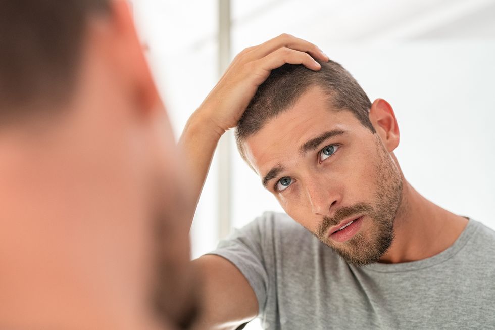 man reflecting on his attitude in the workplace