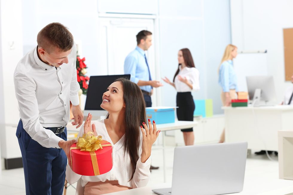Co-worker says thank you by giving a colleague a gift