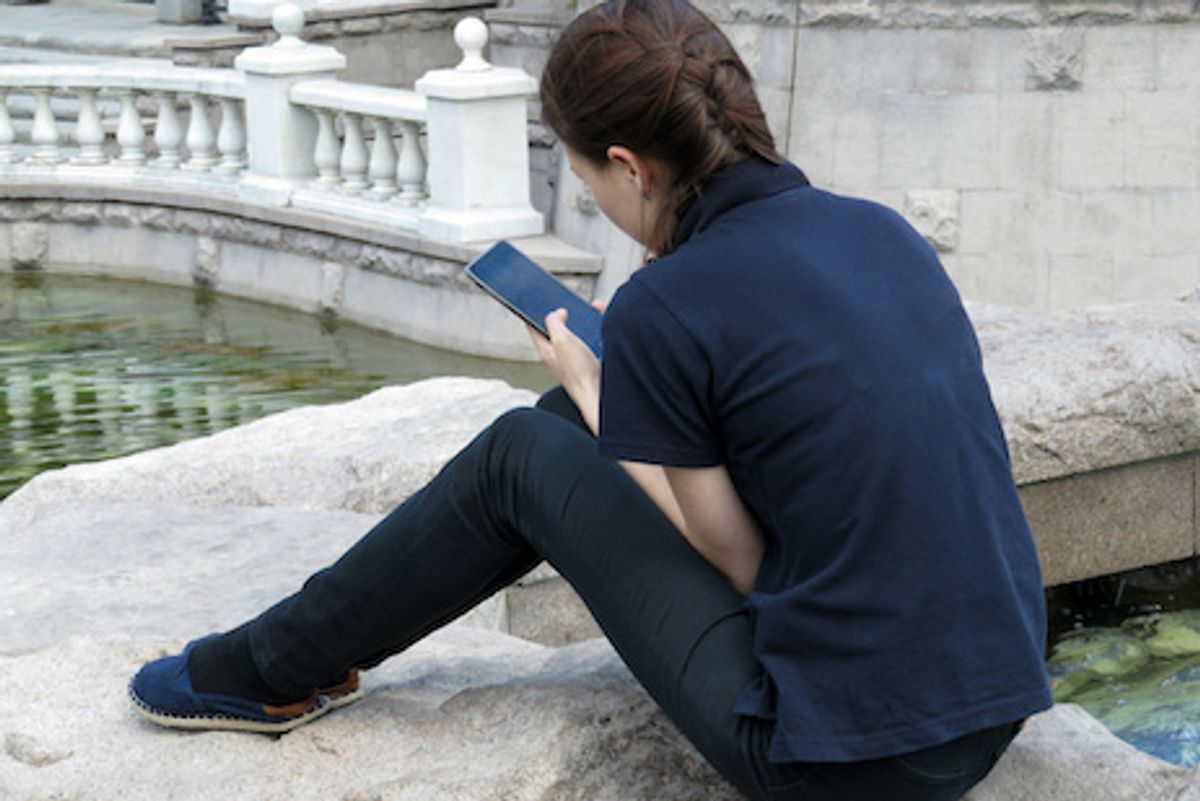 Someone on a smartphone seated near water