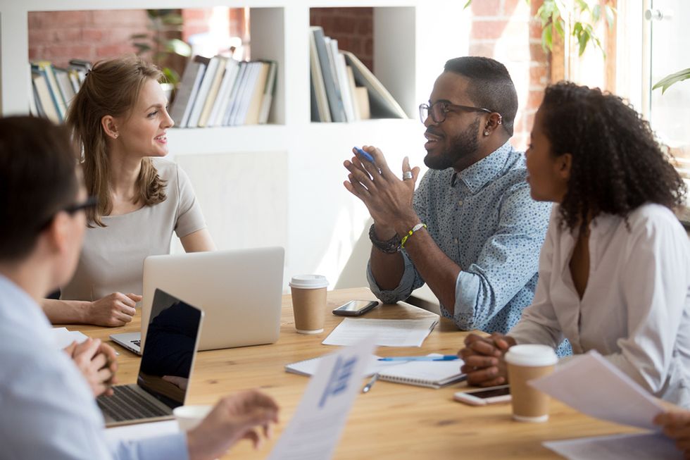 Professional man displaying excellent soft skills during a meeting