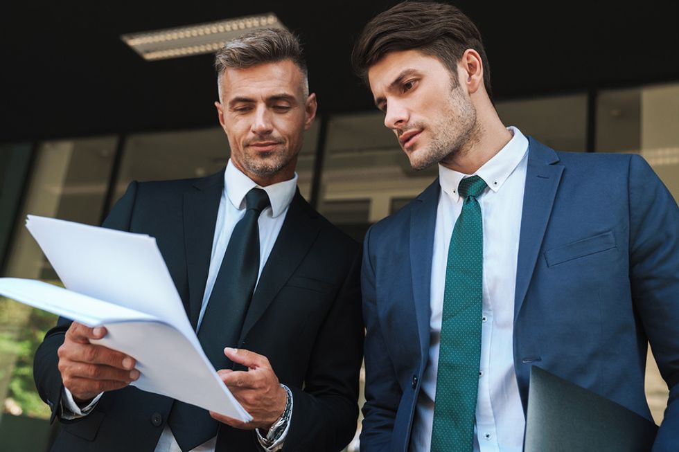 Gen X manager explains a report to a millennial employee
