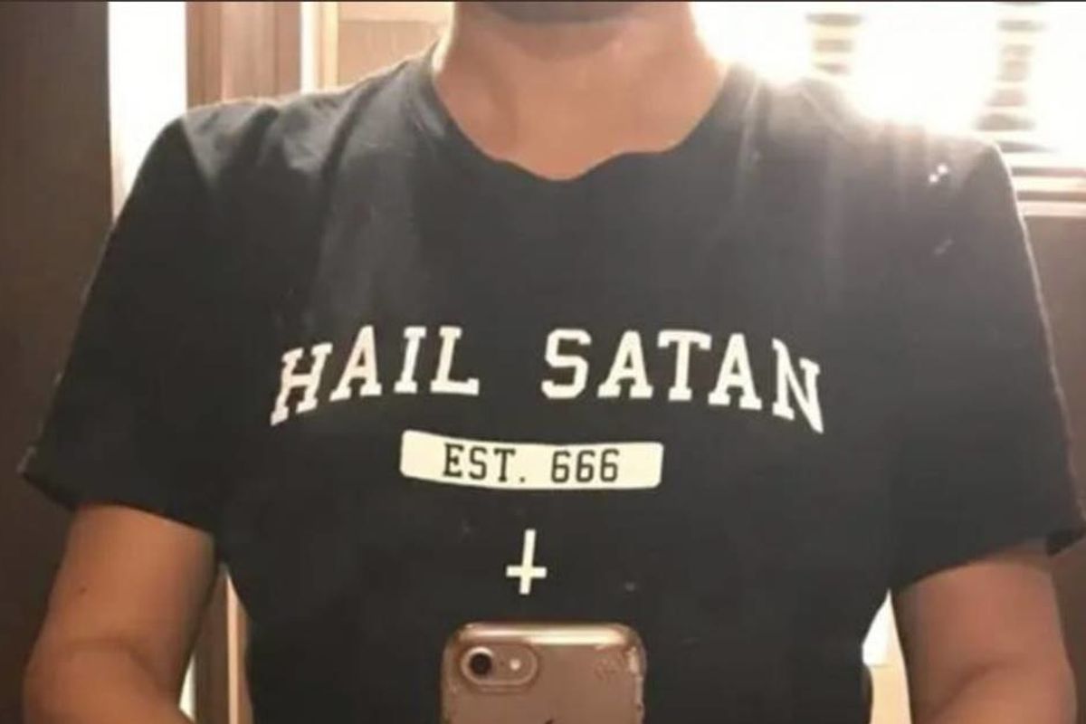 A woman was asked to get off a plane for wearing a shirt that says 'Hail Satan!'