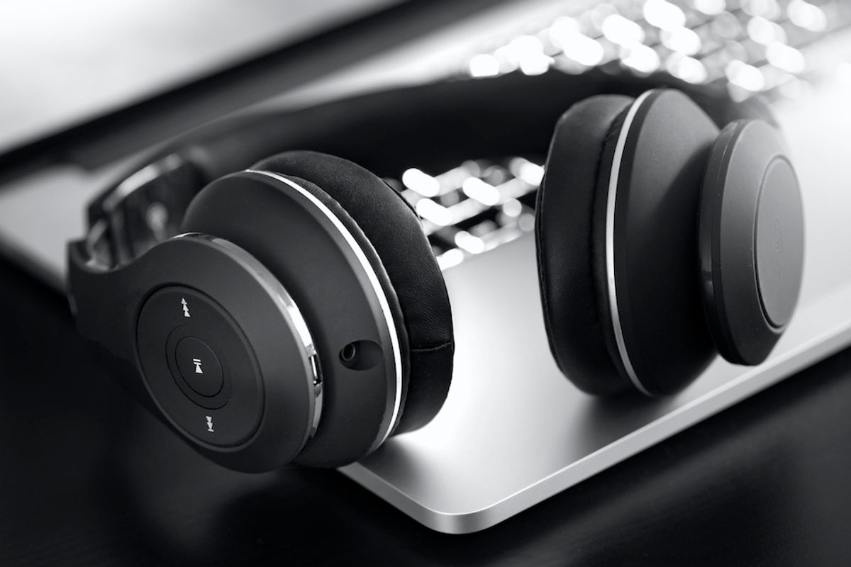A black and white photograph of wireless headphones