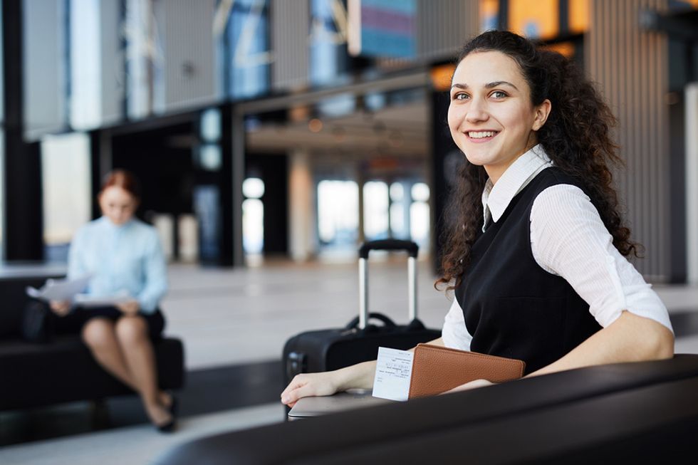 Woman waiting in the airport with a universal charger kit