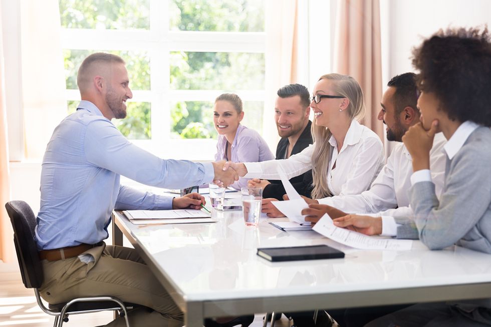 Job applicant introduces himself to a panel of interviewers