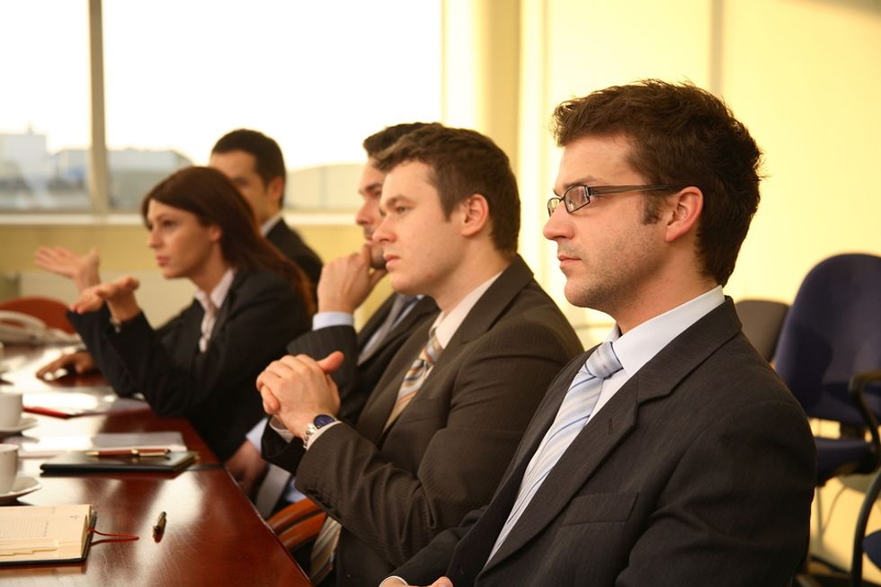 A panel of interviewers listens to a job applicant's answer