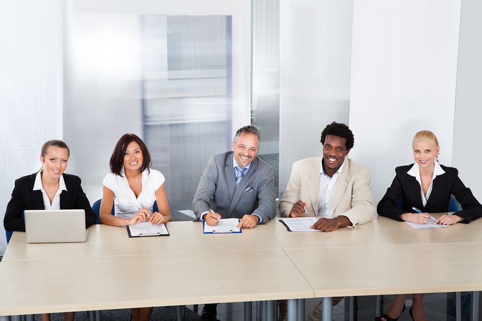 A panel of interviewers prepares to interview a job applicant