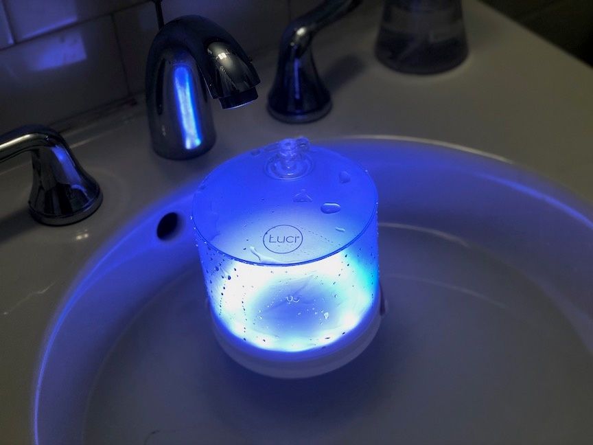 A Luci Connect solar-powered lantern floating in water
