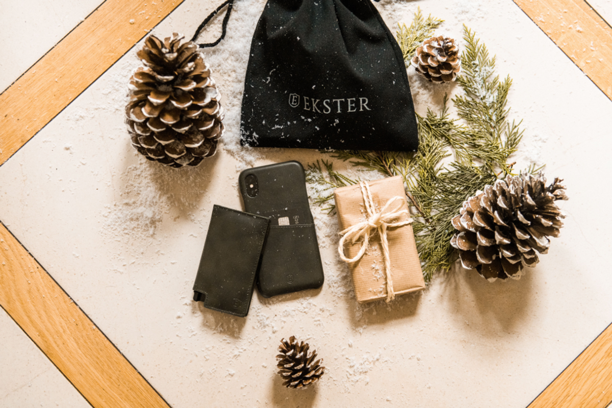 ekster wallet, phone case, and a gift on a table