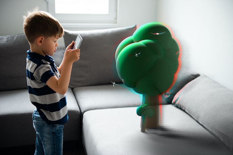 a boy with a smartphone using Augmented reality