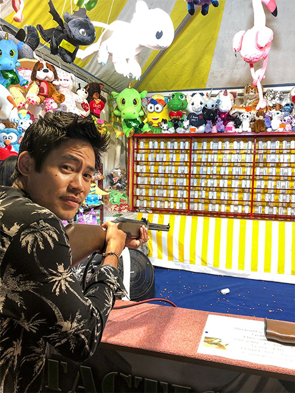 Actor David Lim playing a carnival game in the Trastevere neighborhood of Rome.