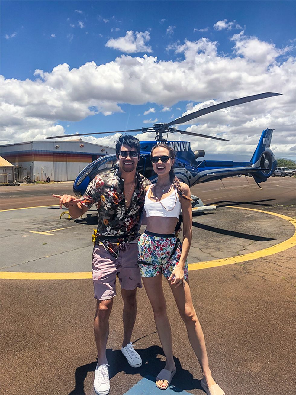 Actor David Lim and wife Marketa Kazdova posing in front of helicopter in Maui.