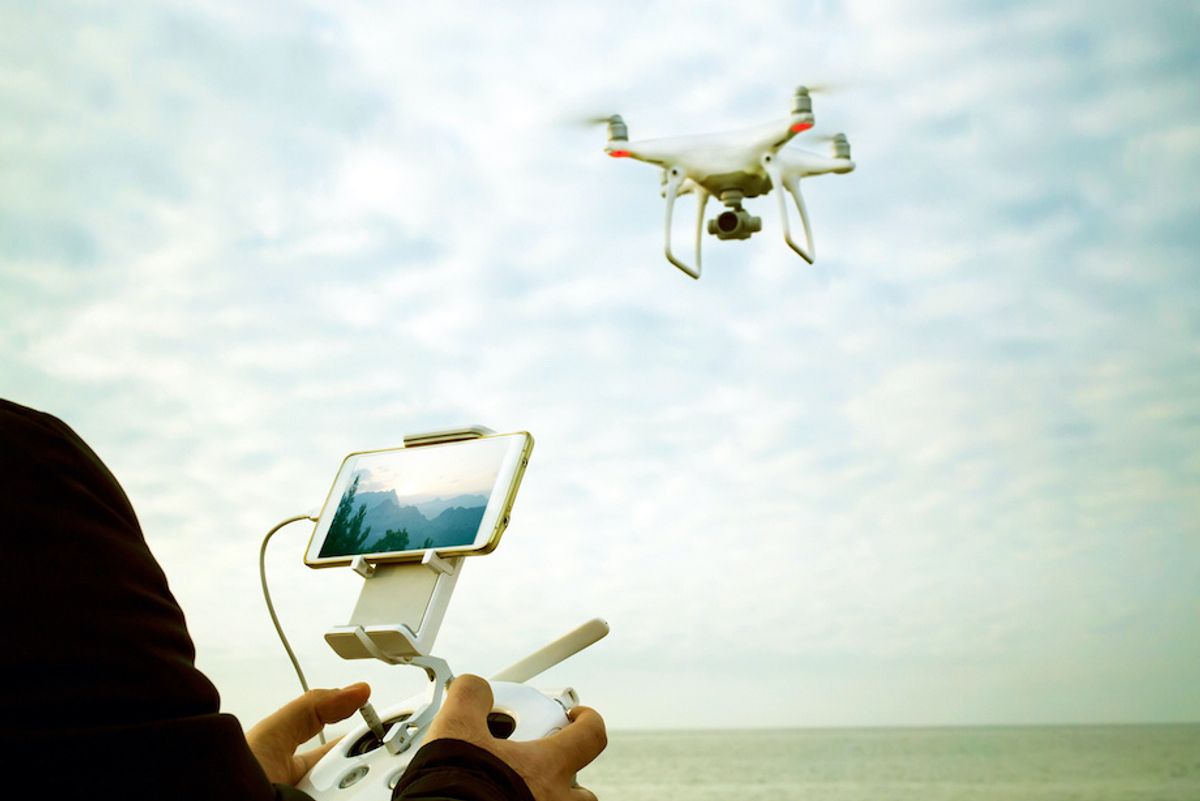 A drone pilot flying a drone